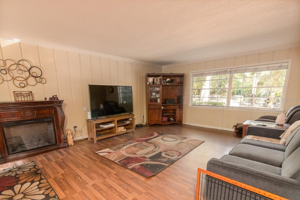 560 North Lake Pleasant Road Apopka, FL 32712 - Photo 4 of 85 a living room with furniture and a flat screen tv