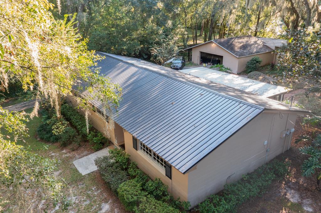 560 North Lake Pleasant Road Apopka, FL 32712 - Photo 66 of 85 a view of a house with a yard and a wooden bench