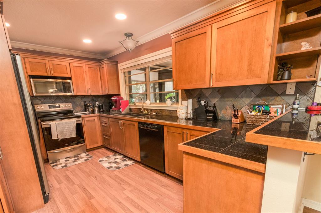 560 North Lake Pleasant Road Apopka, FL 32712 - Photo 8 of 85 a kitchen with stainless steel appliances granite countertop a stove a sink and a refrigerator