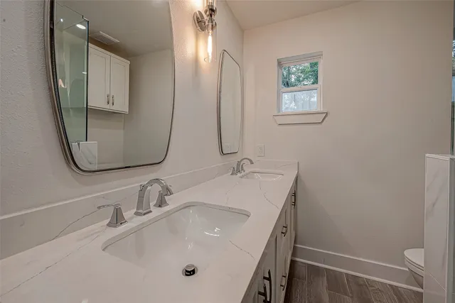 a bathroom with 2 sink and a mirror