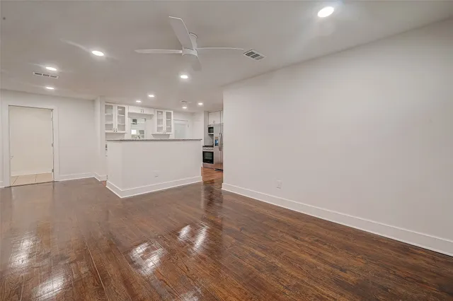 a view of a kitchen with a sink and wooden floor