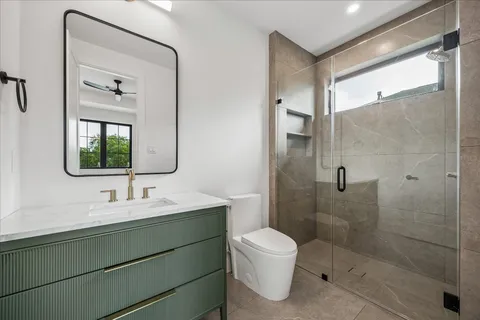 a bathroom with a toilet sink a shower and