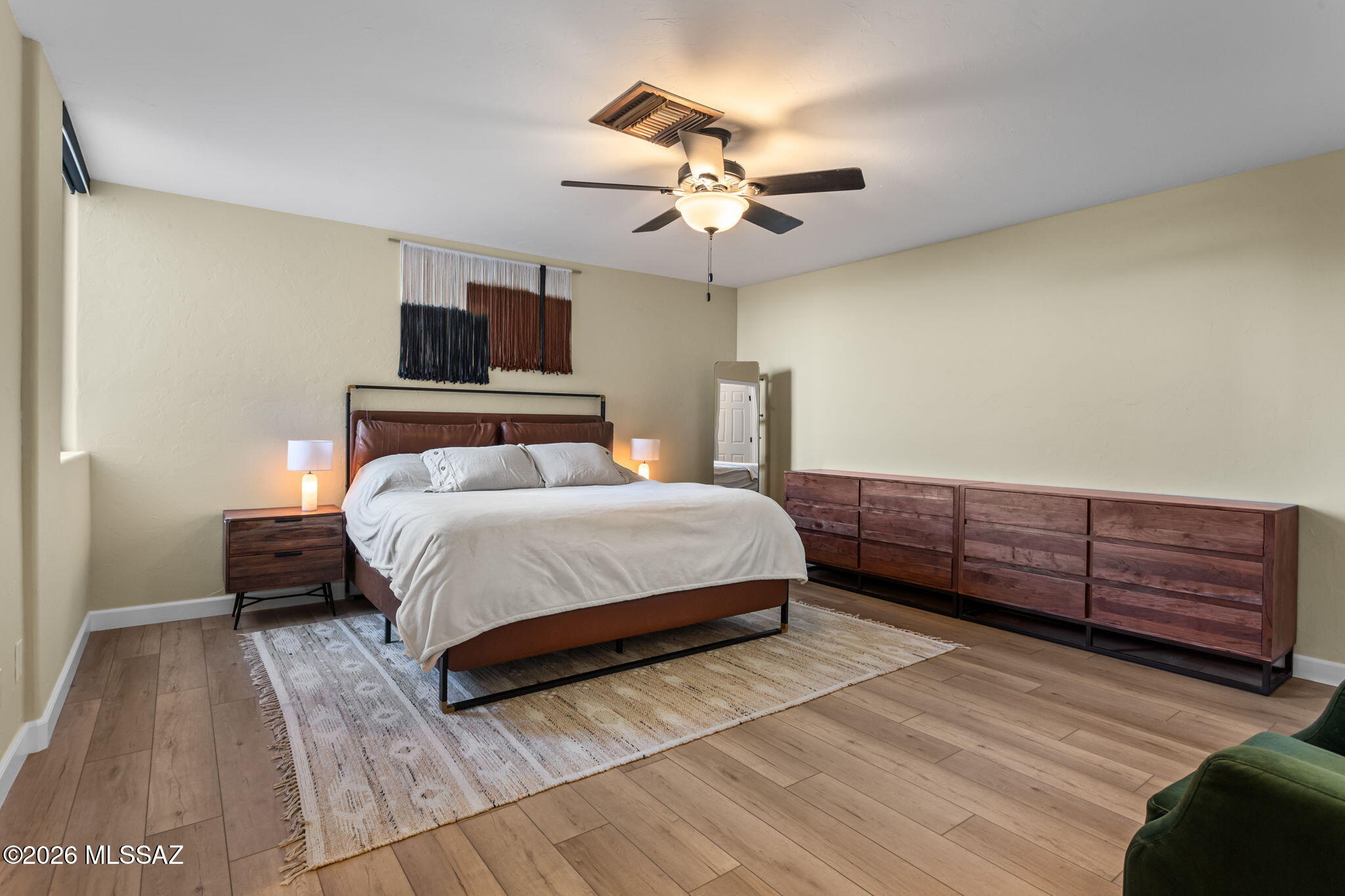 4210 West Mossman Road Tucson, AZ 85746 - Photo 28 of 51 a bedroom with a bed and wooden floor