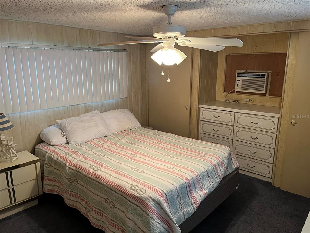 1040 Main Street, Unit 193 Dunedin, FL 34698 - Photo 10 of 16 a bedroom with a bed and a dresser