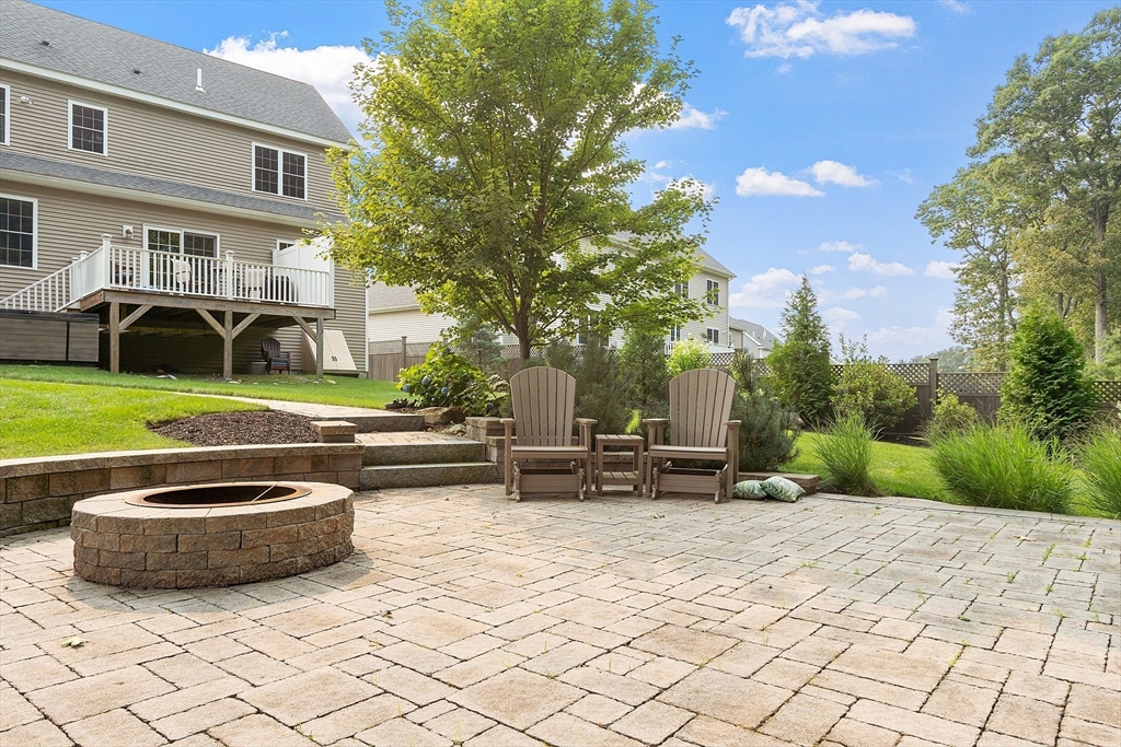 46 Jordan Road Holden, MA 01520 - Photo 35 of 42 a view of a patio with a table and chairs and a fire pit