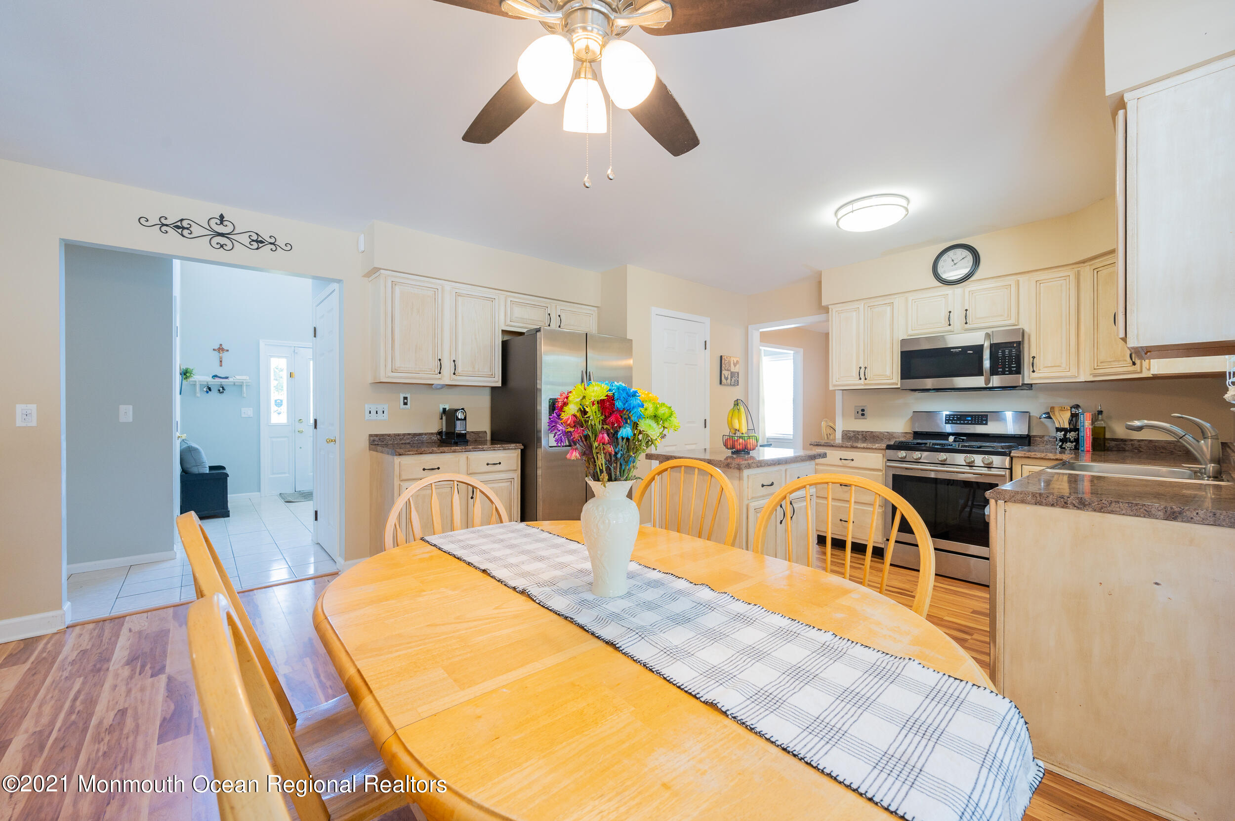 121 Lanyard Road Manahawkin, NJ 08050 - Photo 16 of 39 a kitchen with stainless steel appliances granite countertop a refrigerator a stove top oven a sink dishwasher and white cabinets with wooden floor