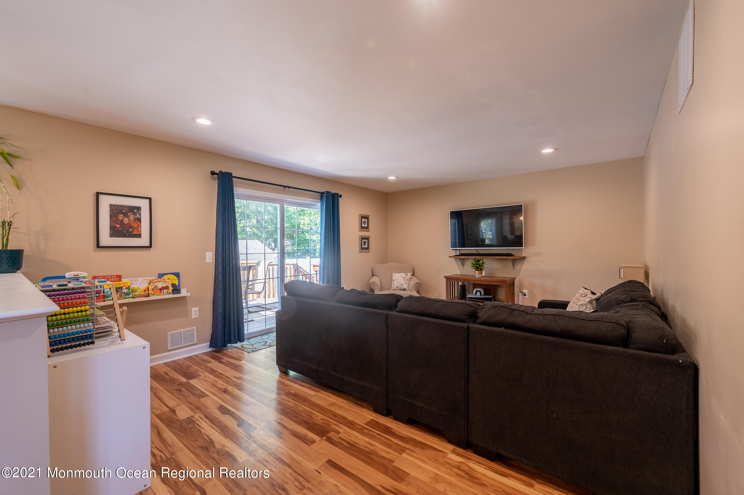 121 Lanyard Road Manahawkin, NJ 08050 - Photo 20 of 39 a living room with furniture and a flat screen tv