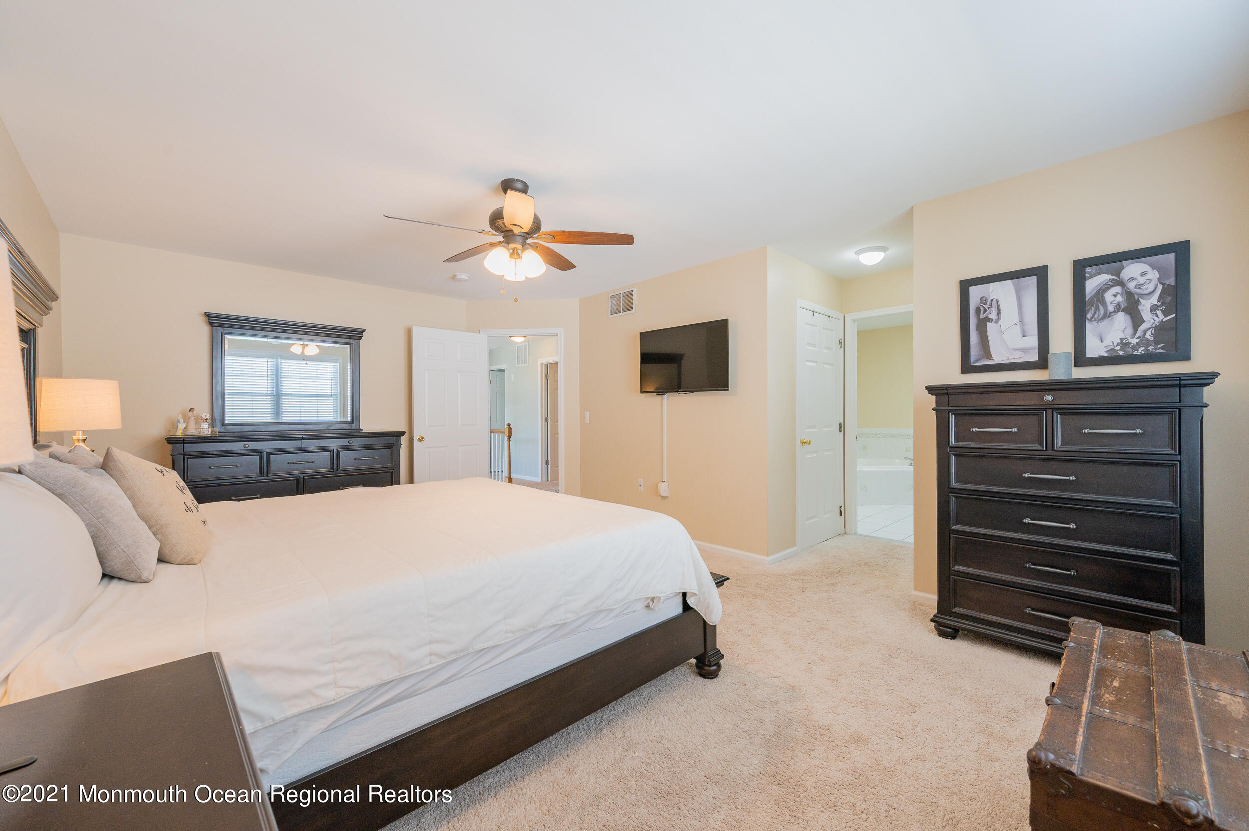121 Lanyard Road Manahawkin, NJ 08050 - Photo 25 of 39 a bedroom with a bed and a chandelier