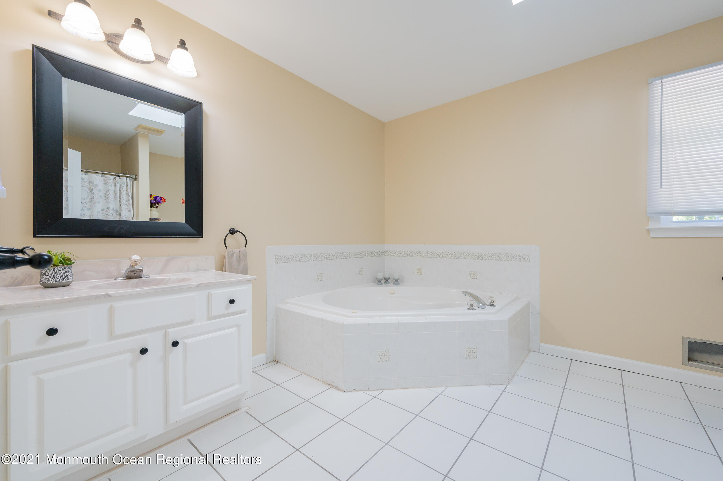 121 Lanyard Road Manahawkin, NJ 08050 - Photo 26 of 39 a spacious bathroom with a double vanity sink mirror and bathtub