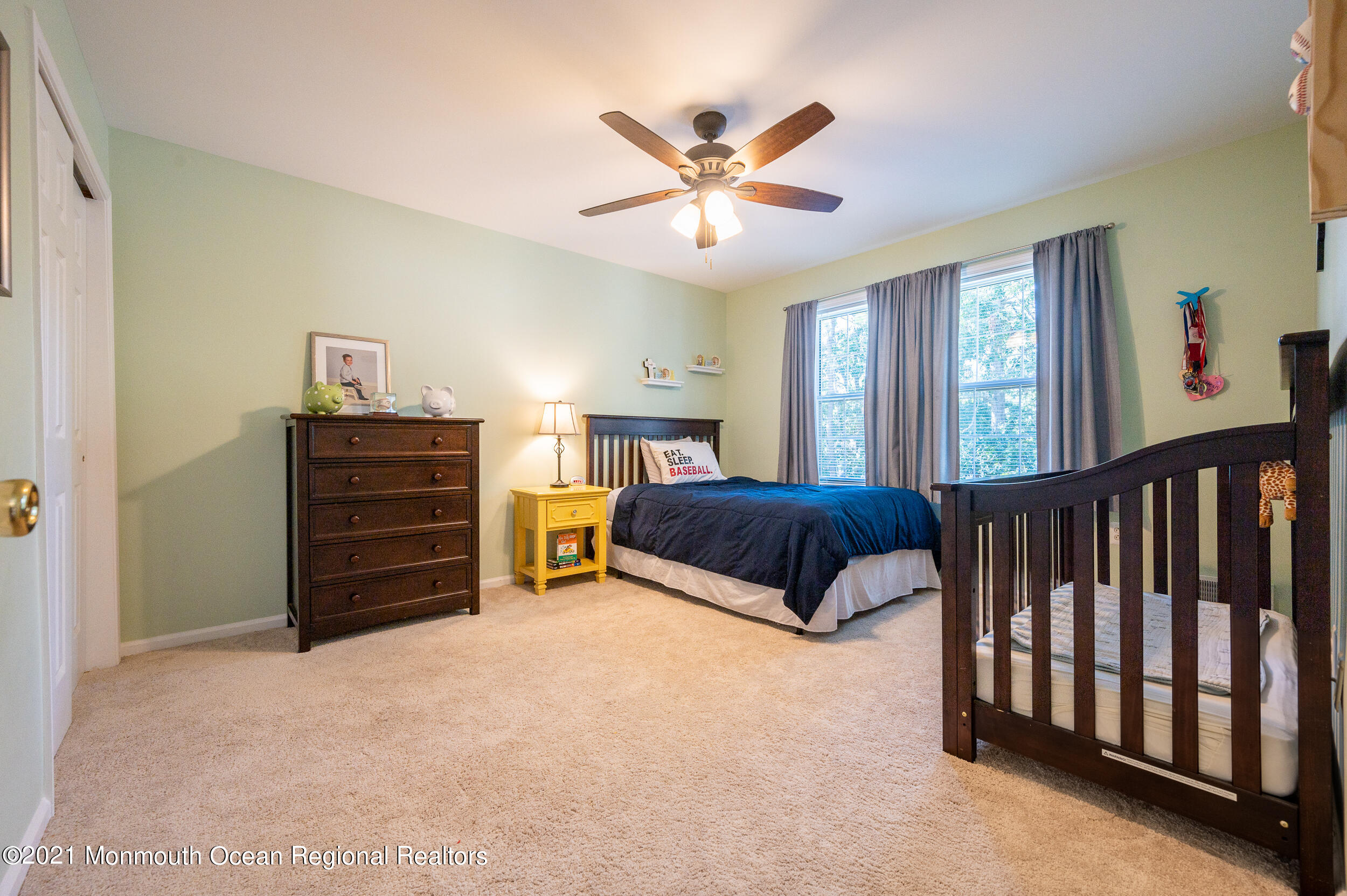 121 Lanyard Road Manahawkin, NJ 08050 - Photo 28 of 39 a bedroom with a bed and a chandelier