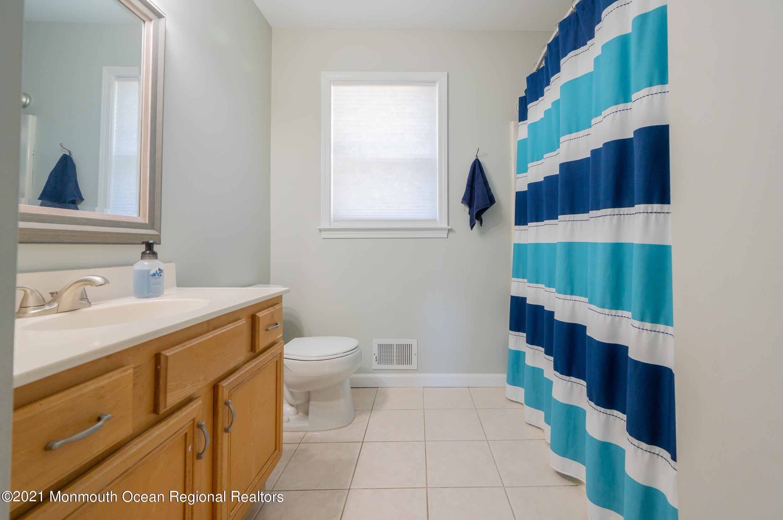 121 Lanyard Road Manahawkin, NJ 08050 - Photo 31 of 39 a bathroom with a sink and a mirror