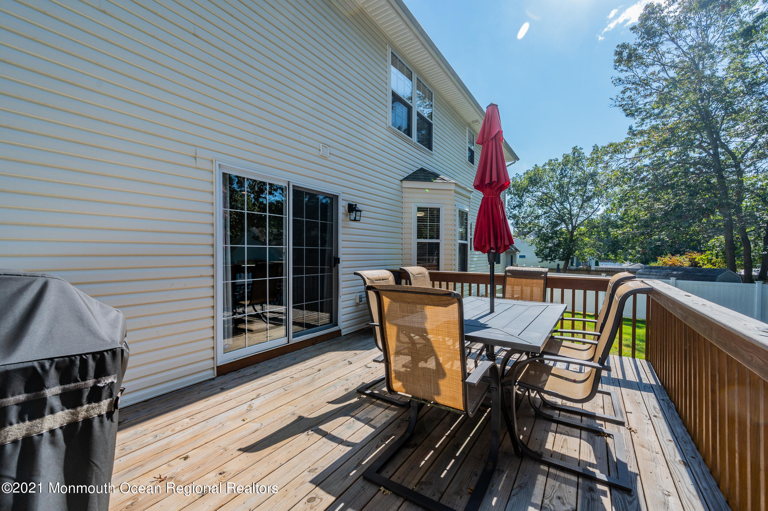 121 Lanyard Road Manahawkin, NJ 08050 - Photo 32 of 39 a view of a chair and table on the deck