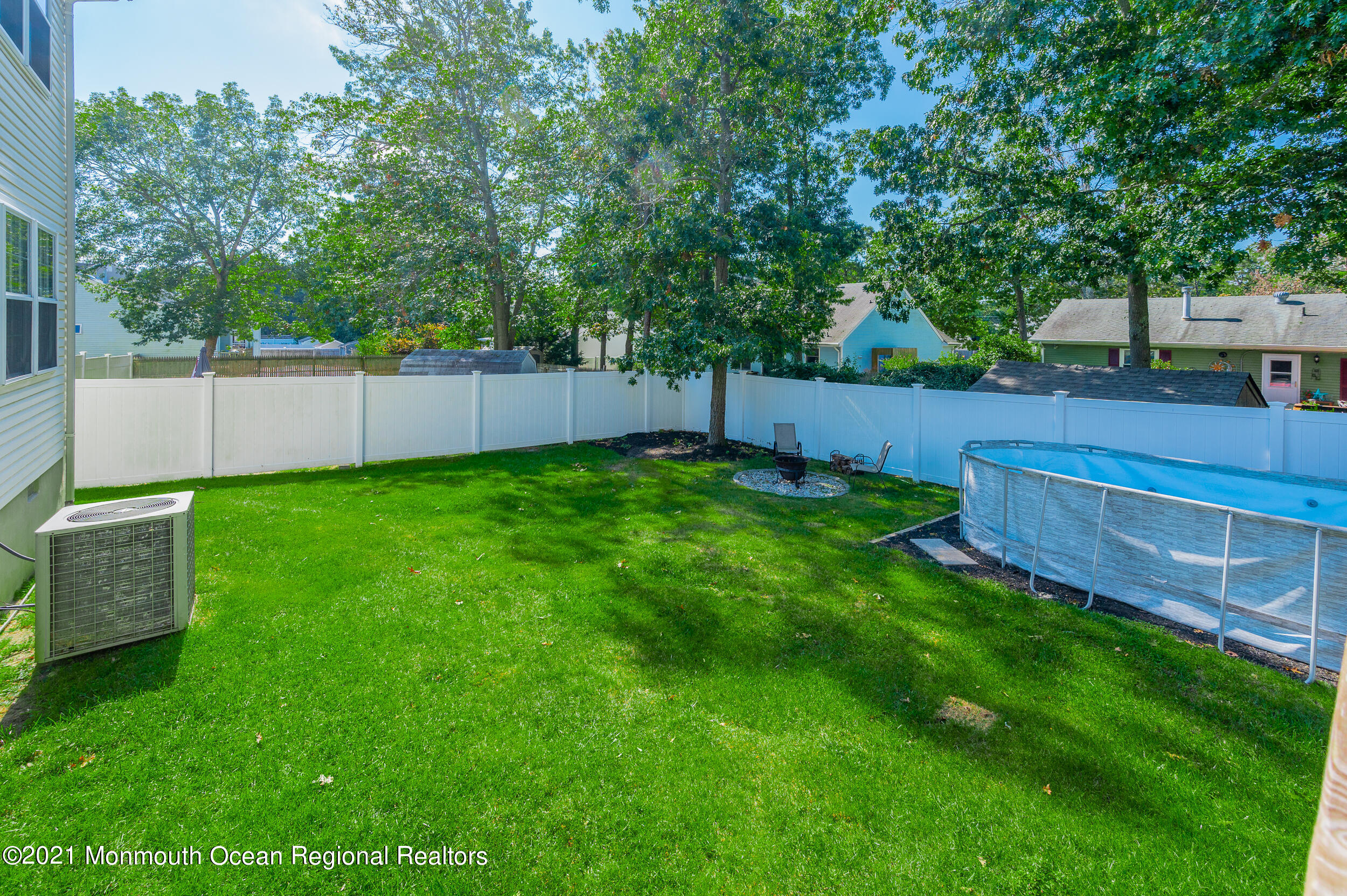 121 Lanyard Road Manahawkin, NJ 08050 - Photo 37 of 39 a view of a backyard with a small cabin