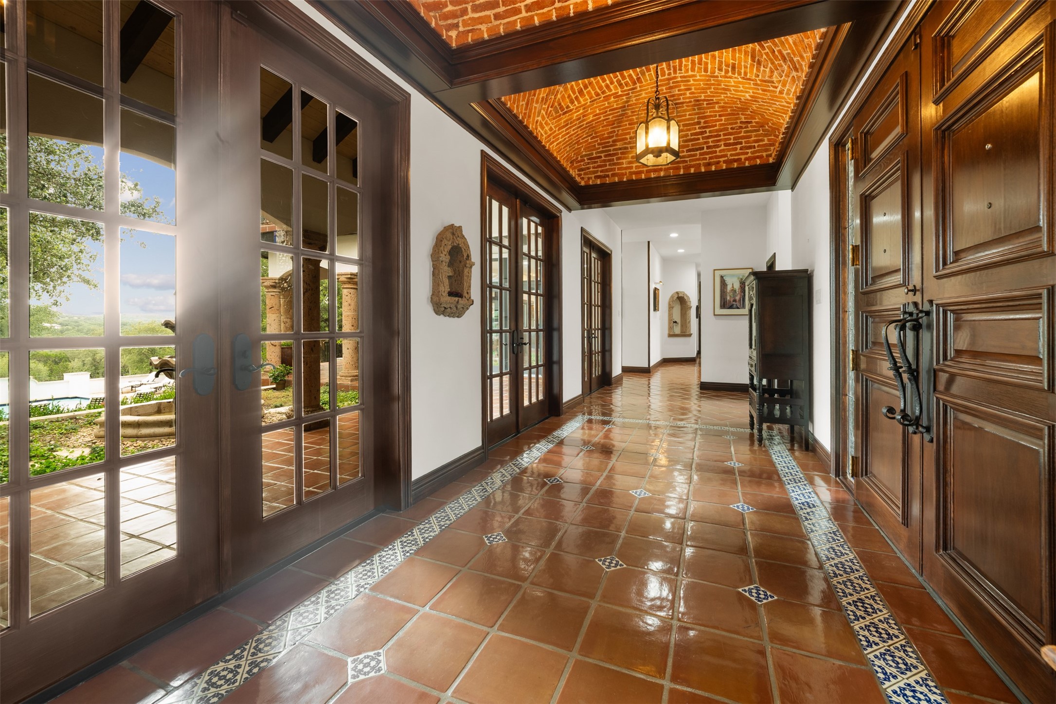 34000 Smithson Valley Road Bulverde, TX 78163 - Photo 4 of 50 Imported terracotta tile floors, rich wood millwork, and a stunning brick barrel-vault ceiling create a memorable introduction. Natural light and old-world craftsmanship define this sophisticated entry hall.
Photo 5 – Formal Dining Room