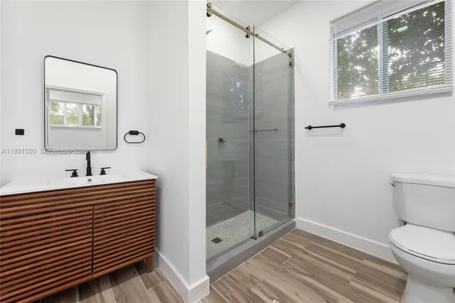 a bathroom with a sink a mirror and a shower