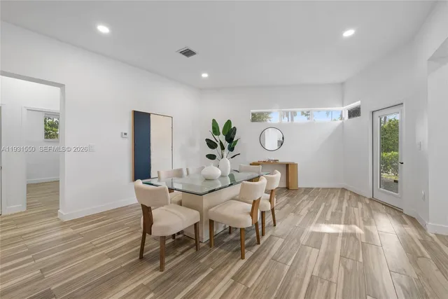 a view of a dining room with furniture and wooden floor