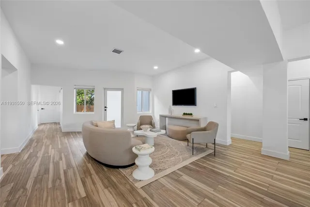 a living room with furniture and a flat screen tv