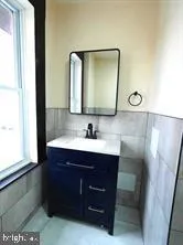 a bathroom with a sink vanity and mirror
