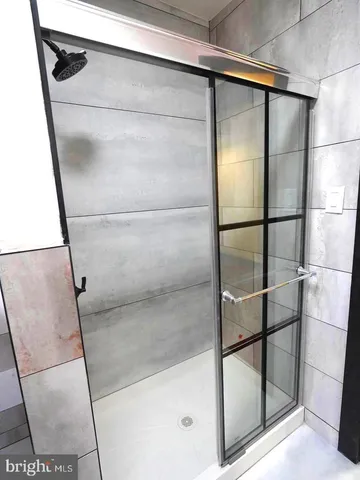a bathroom with a glass shower door