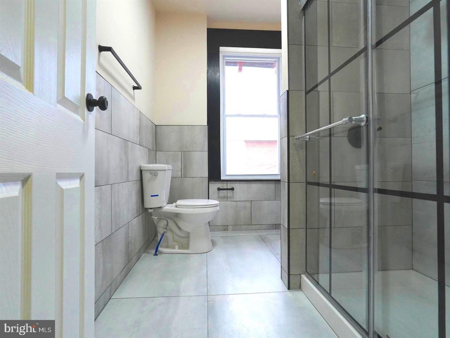 5013 Chester Avenue, Unit 1 Philadelphia, PA 19143 - Photo 8 of 12 a bathroom with a toilet and a shower