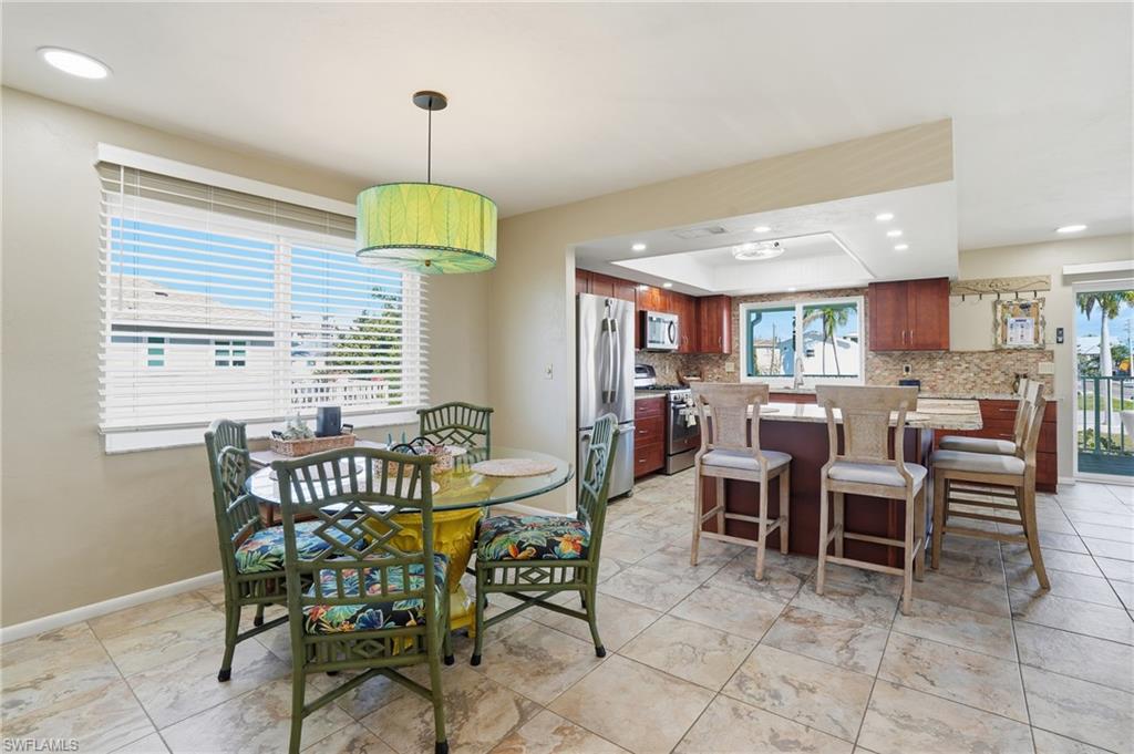 170 Redfish Road Fort Myers Beach, FL 33931 - Photo 15 of 48 a dining room with furniture and window