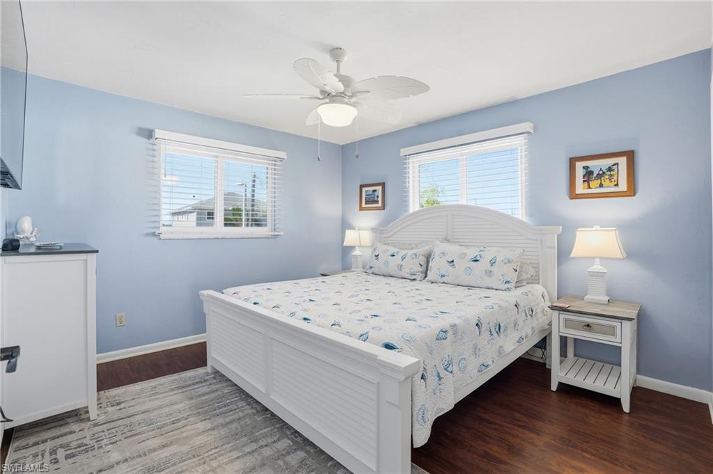 170 Redfish Road Fort Myers Beach, FL 33931 - Photo 16 of 48 a bedroom with a bed and a table
