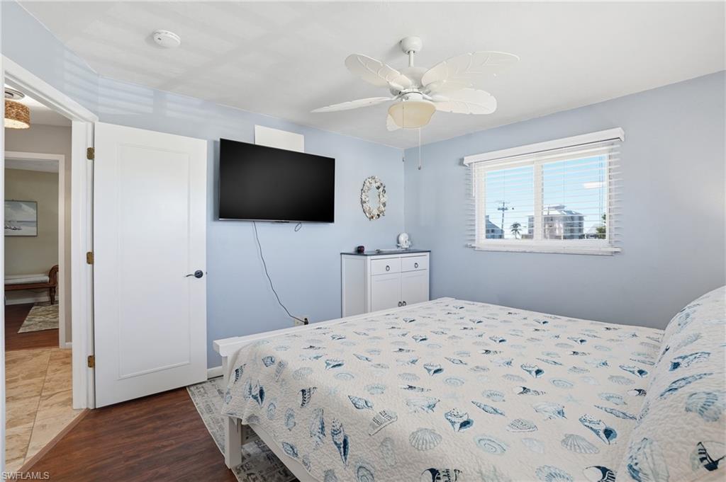 170 Redfish Road Fort Myers Beach, FL 33931 - Photo 17 of 48 a bedroom with a bed and a flat screen tv