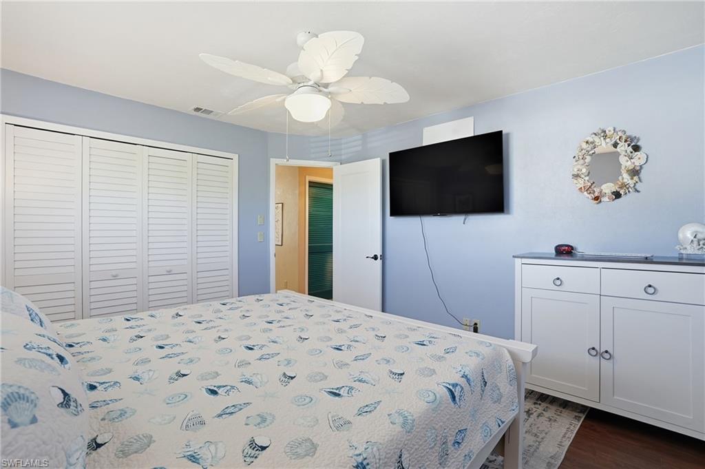 170 Redfish Road Fort Myers Beach, FL 33931 - Photo 18 of 48 a bedroom with a bed and a flat screen tv