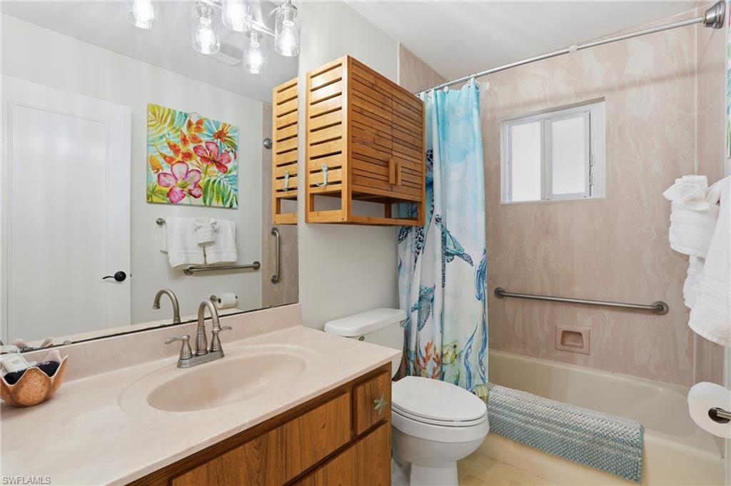 170 Redfish Road Fort Myers Beach, FL 33931 - Photo 19 of 48 a bathroom with a sink a toilet and shower