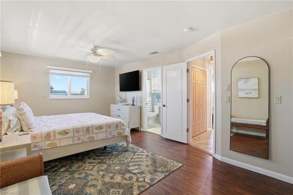 170 Redfish Road Fort Myers Beach, FL 33931 - Photo 21 of 48 a spacious bedroom with a bed and a flat screen tv