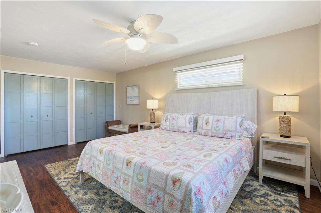 170 Redfish Road Fort Myers Beach, FL 33931 - Photo 22 of 48 a bedroom with a bed and a chandelier