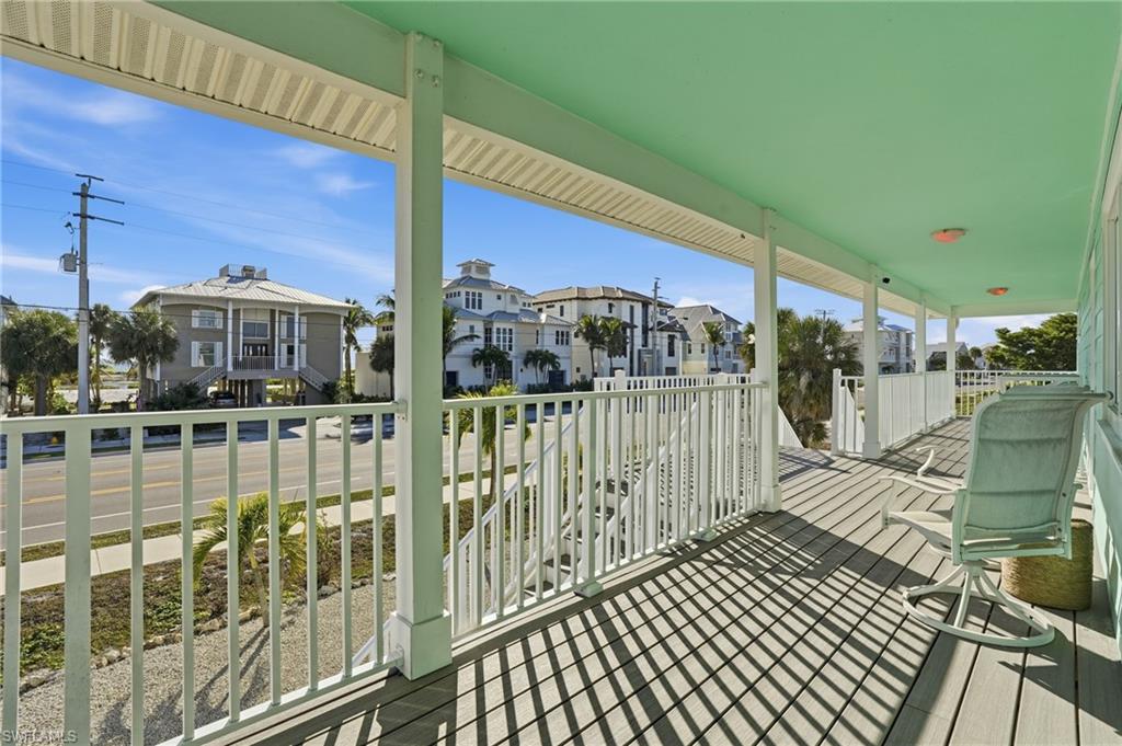 170 Redfish Road Fort Myers Beach, FL 33931 - Photo 27 of 48 a view of a balcony with a floor to ceiling window stairs
