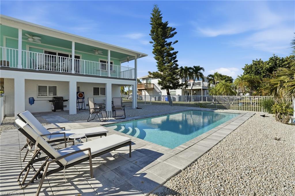 170 Redfish Road Fort Myers Beach, FL 33931 - Photo 31 of 48 a view of a patio with swimming pool table and chairs