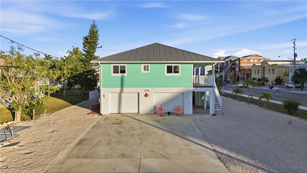 170 Redfish Road Fort Myers Beach, FL 33931 - Photo 36 of 48 a view of a house next to a yard