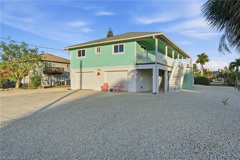 170 Redfish Road Fort Myers Beach, FL 33931 - Photo 37 of 48 a front view of a house with a yard