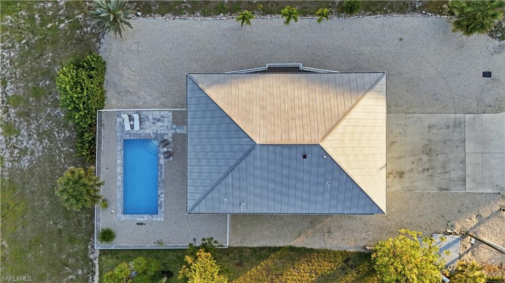 170 Redfish Road Fort Myers Beach, FL 33931 - Photo 42 of 48 an aerial view of a house with swimming pool and garden
