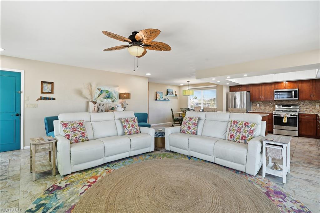 170 Redfish Road Fort Myers Beach, FL 33931 - Photo 7 of 48 a living room with furniture kitchen view and a chandelier