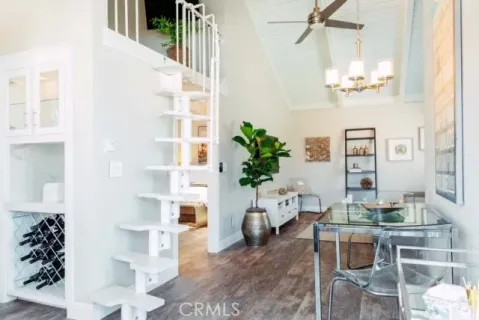 a living room with furniture flowers and a chandelier