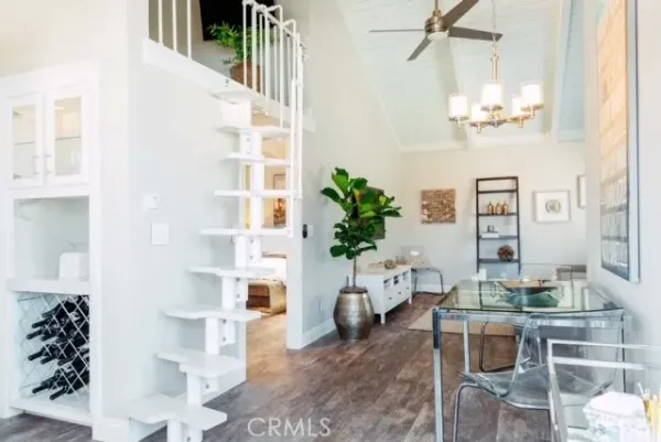 a living room with furniture flowers and a chandelier