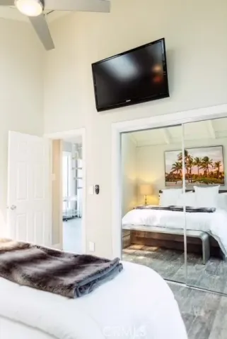 a bedroom with a bed and a flat screen tv