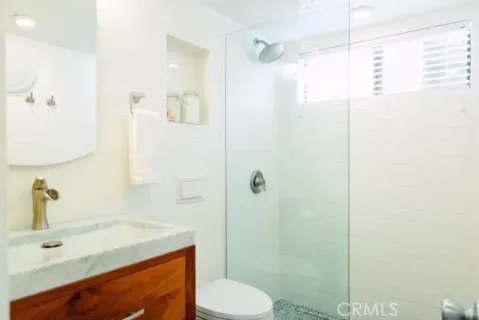a bathroom with a sink toilet and shower