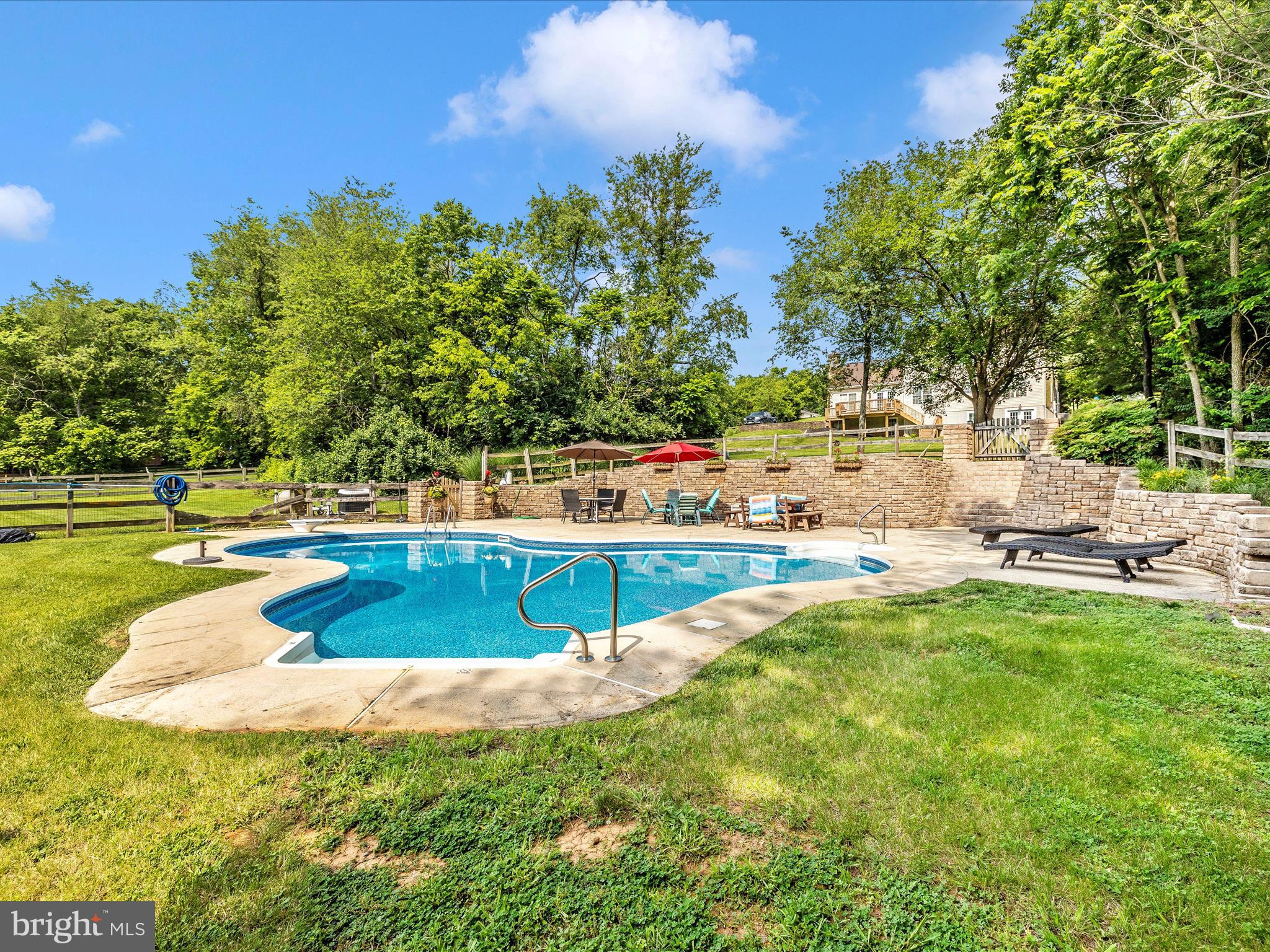 9503 Childacrest Drive Boonsboro, MD 21713 - Photo 59 of 59 a view of a swimming pool with an outdoor seating and a yard