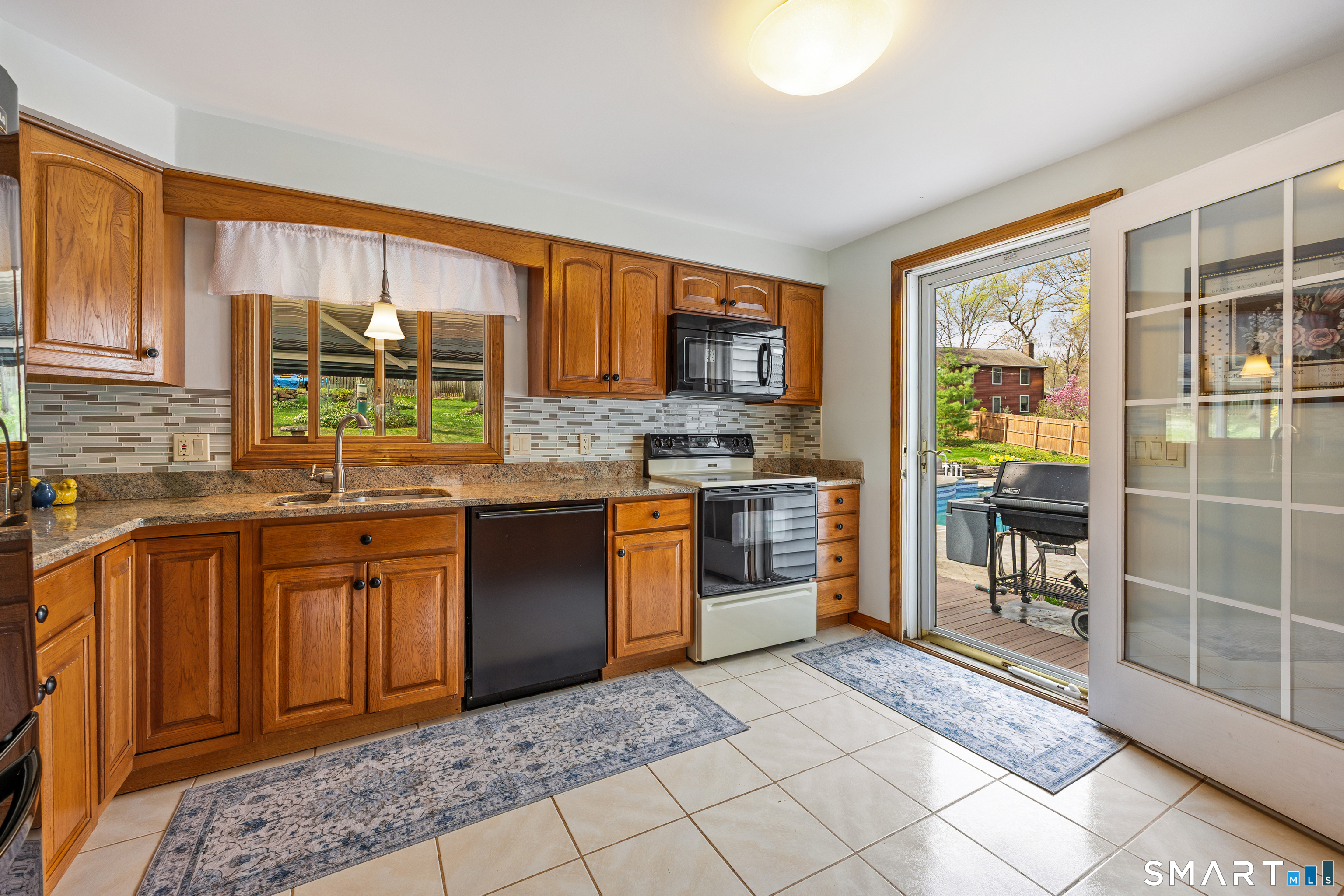 42 Chimney Sweep Road Wallingford, CT 06492 - Photo 11 of 40 a kitchen with stainless steel appliances granite countertop a stove a sink and a microwave