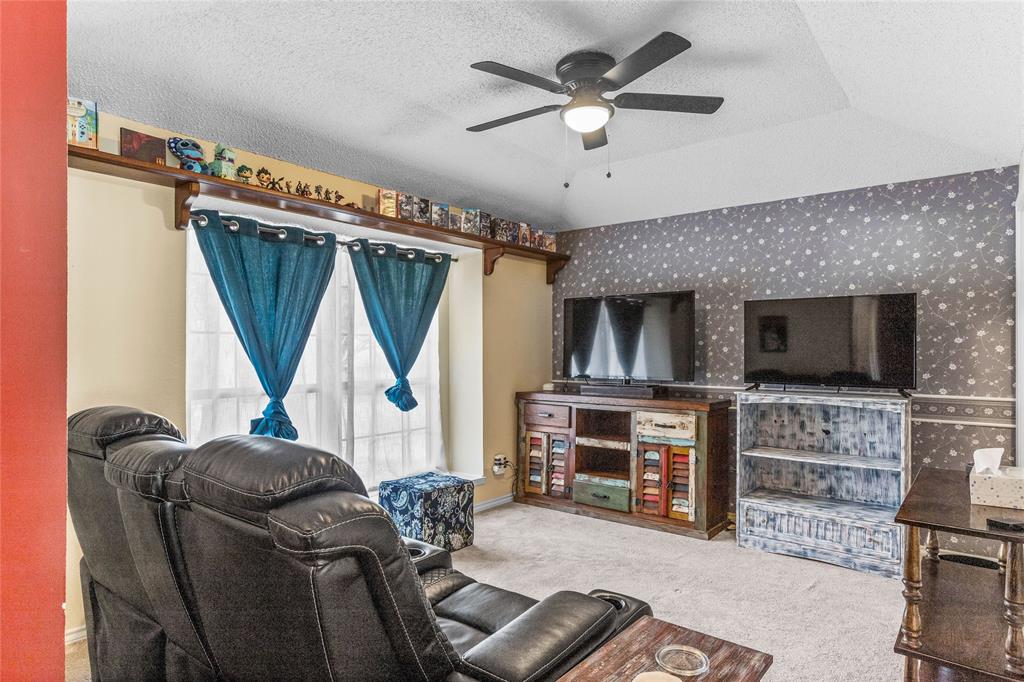 2626 Collard Road Arlington, TX 76017 - Photo 15 of 40 a living room with furniture a flat screen tv and a fireplace