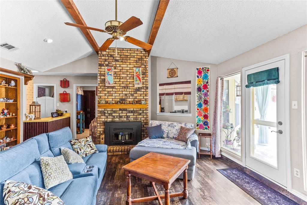 2626 Collard Road Arlington, TX 76017 - Photo 21 of 40 a living room with furniture a fireplace and a flat screen tv