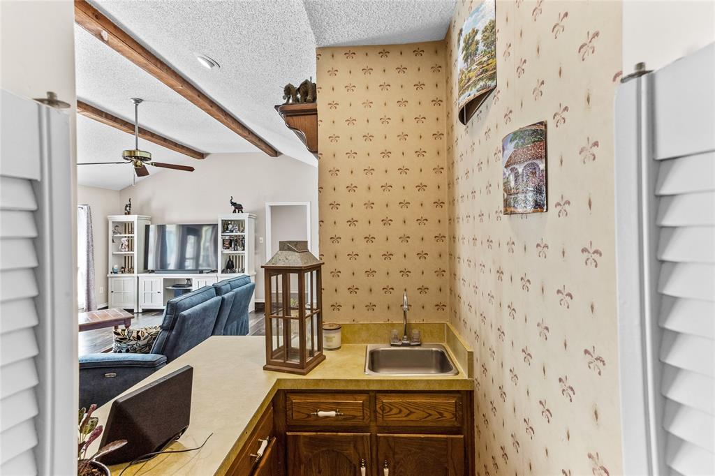 2626 Collard Road Arlington, TX 76017 - Photo 25 of 40 a kitchen with a sink stove and refrigerator