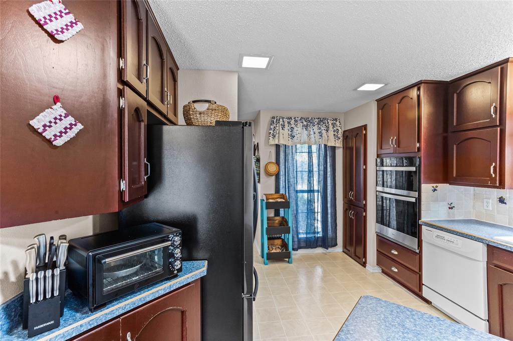 2626 Collard Road Arlington, TX 76017 - Photo 30 of 40 a kitchen with stainless steel appliances granite countertop a refrigerator and a stove