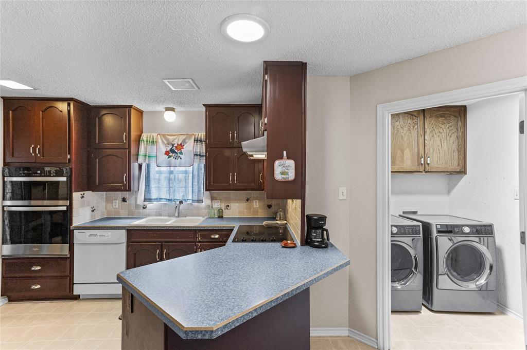 2626 Collard Road Arlington, TX 76017 - Photo 31 of 40 a kitchen with a sink a stove and cabinets