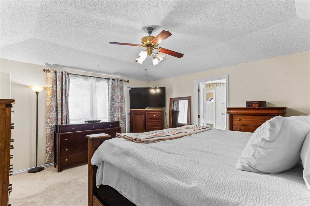 2626 Collard Road Arlington, TX 76017 - Photo 34 of 40 a bedroom with a bed and a chandelier