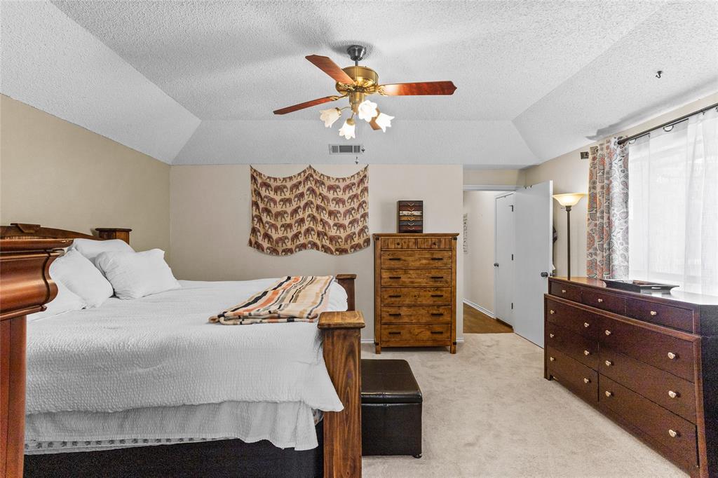 2626 Collard Road Arlington, TX 76017 - Photo 36 of 40 a bedroom with a bed and a chandelier